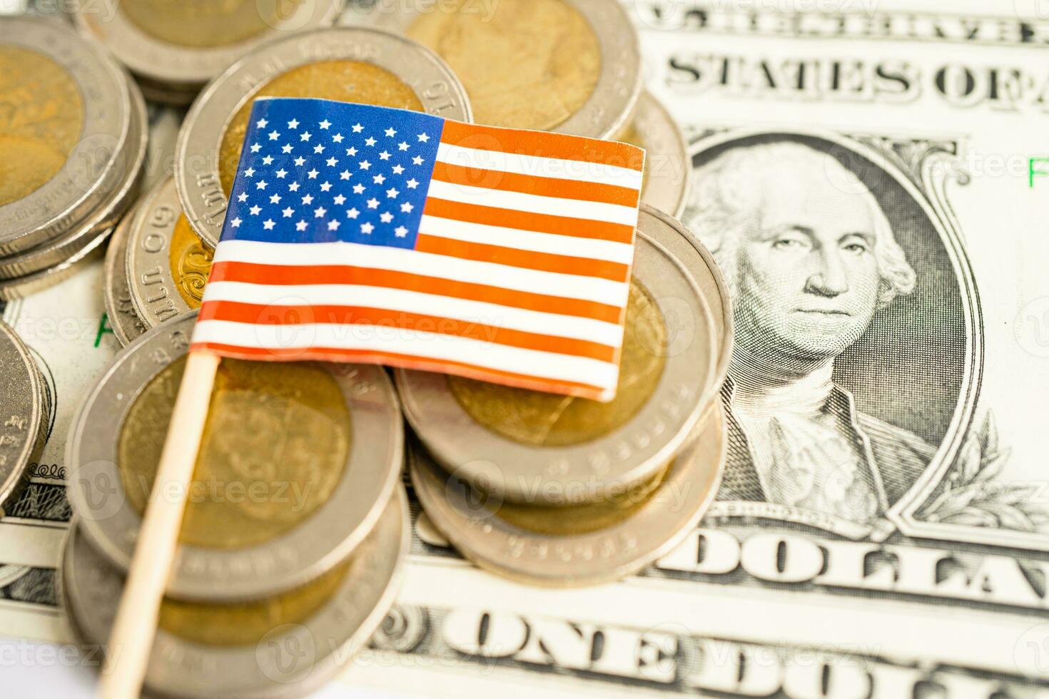Stack of coins with USA America flag and US dollar banknotes. photo