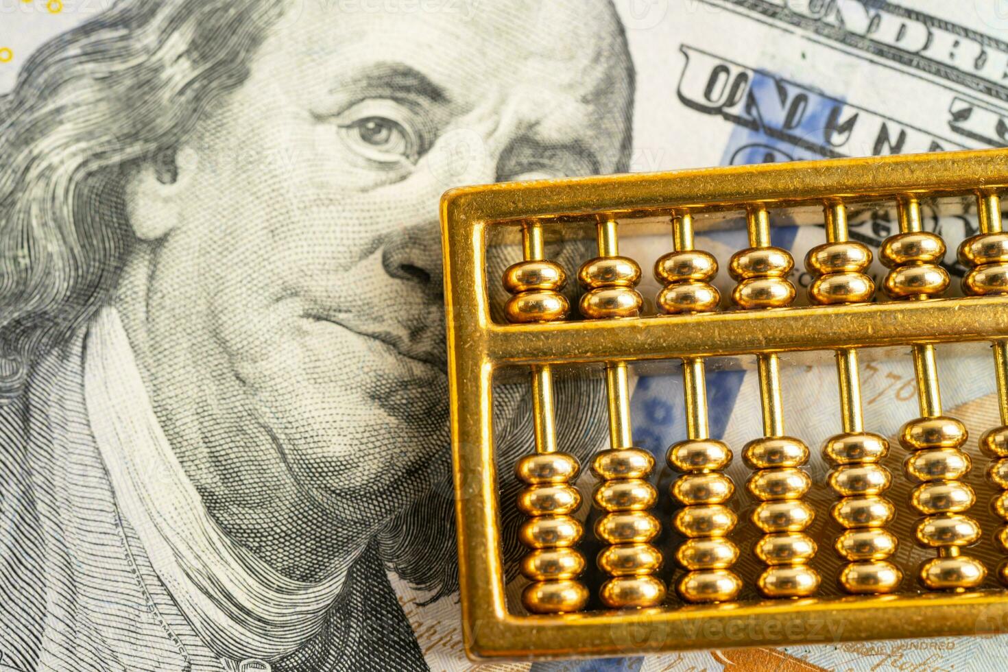 Gold abacus on USA dollar banknote money, economy finance exchange trade investment concept. photo