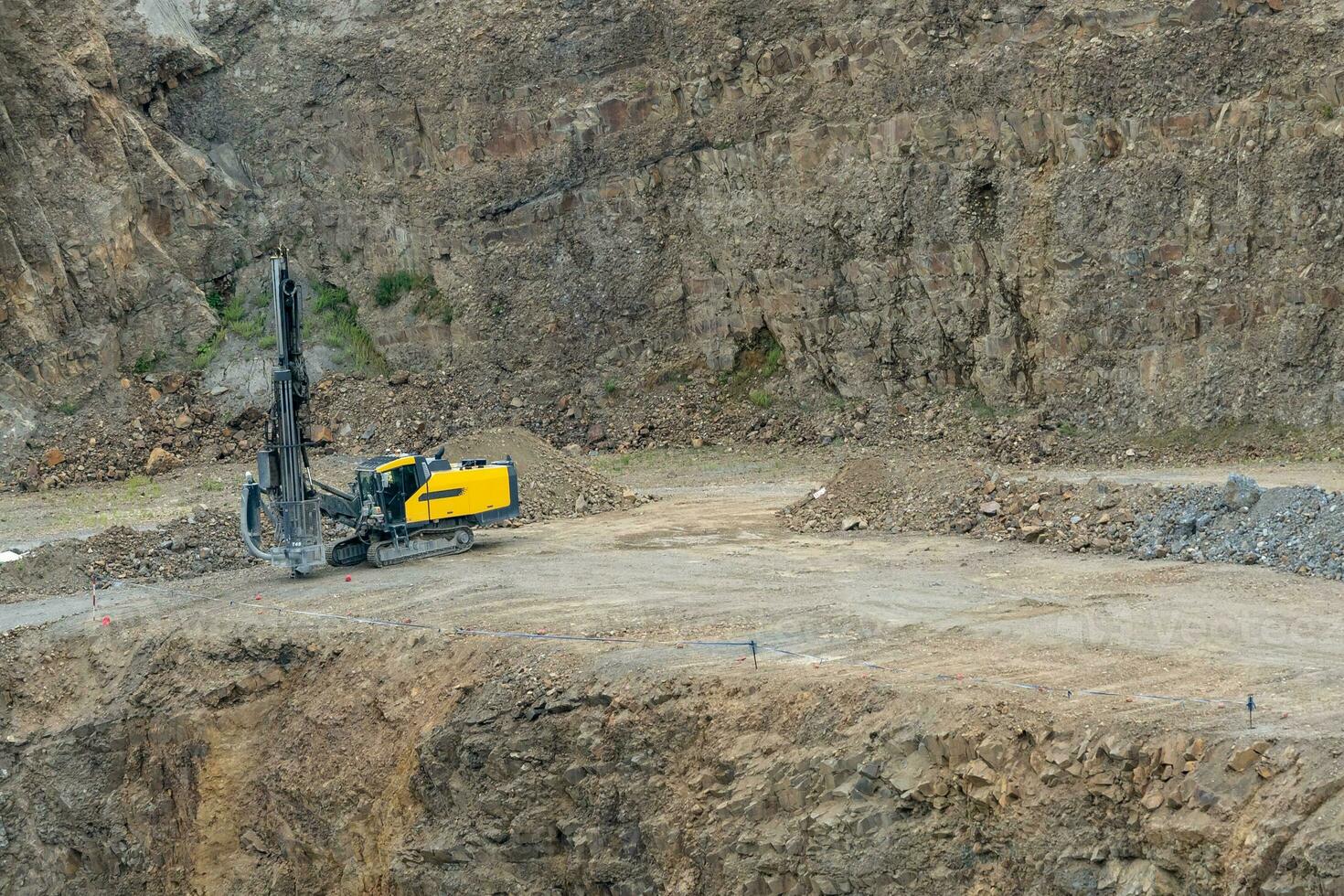 Opencast mining quarry with mining drilling machine. Mining in the granite quarry. Mining industry. photo