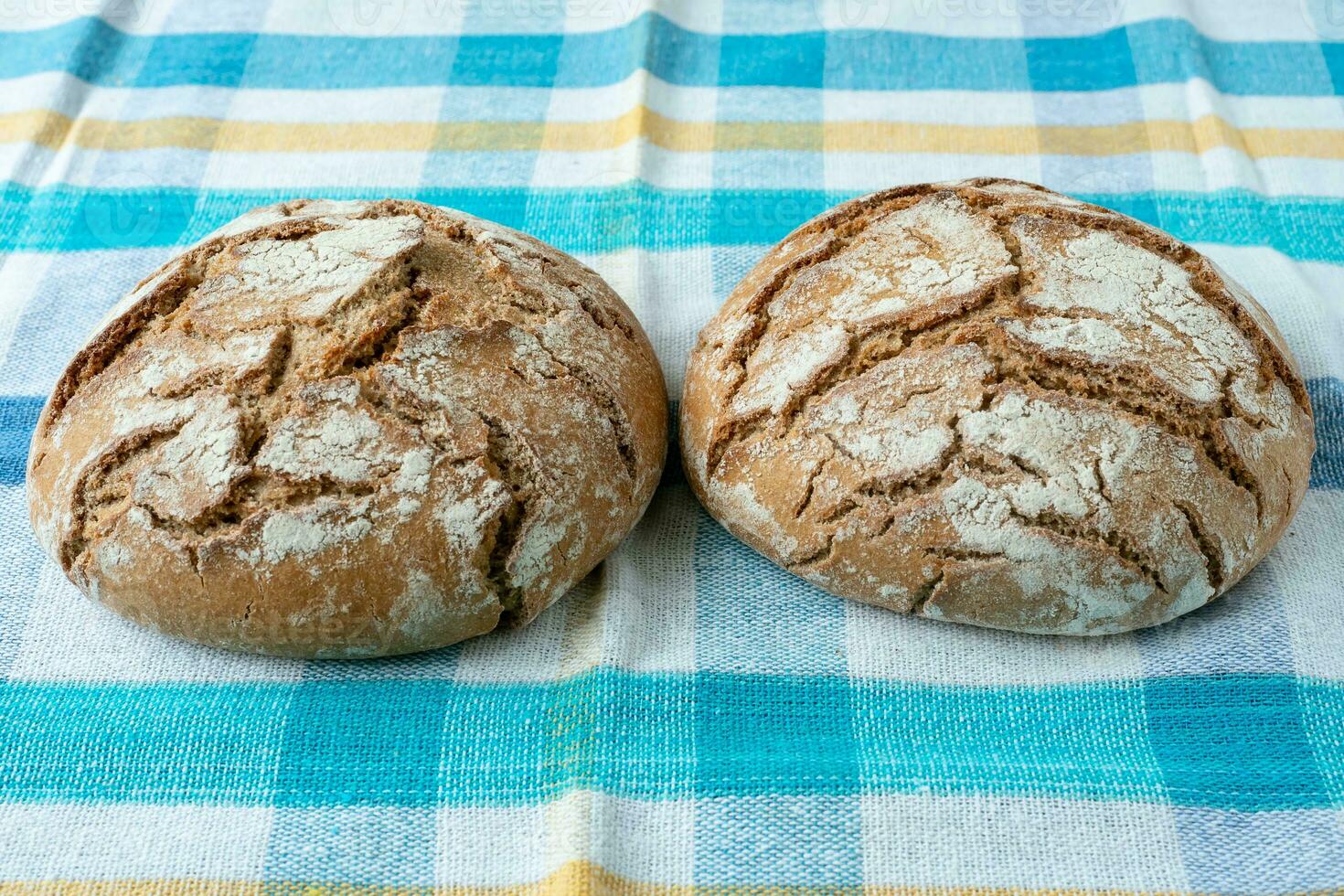 Fresh rustic bread on a checkered towel photo