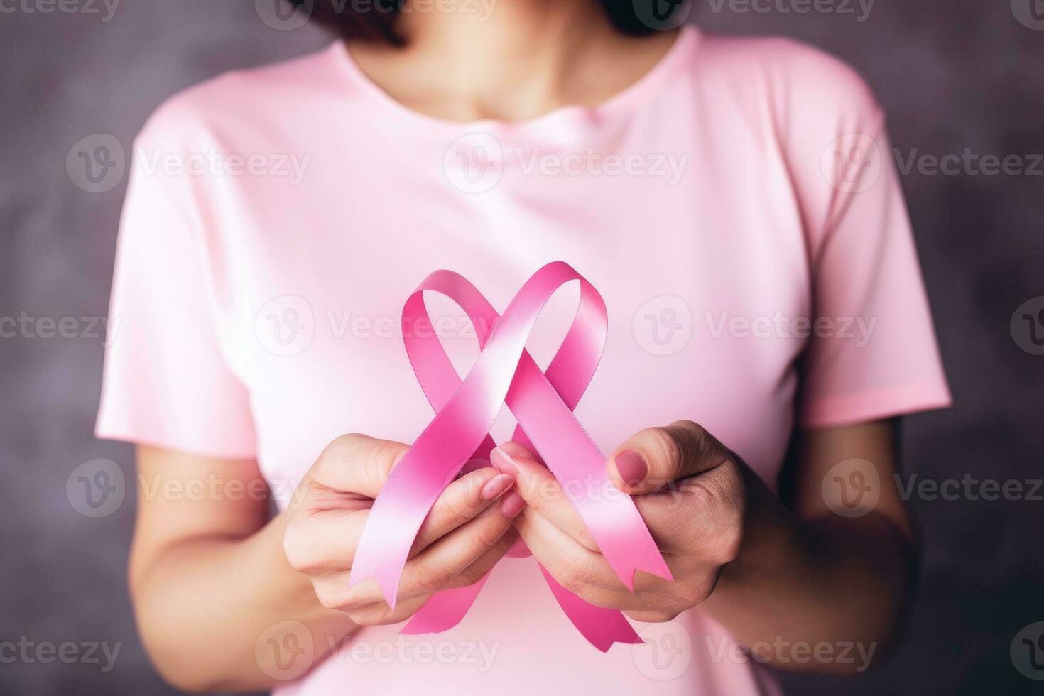 ai generado rosado cinta retenida en hembra manos. símbolo de el lucha en contra pecho cáncer foto