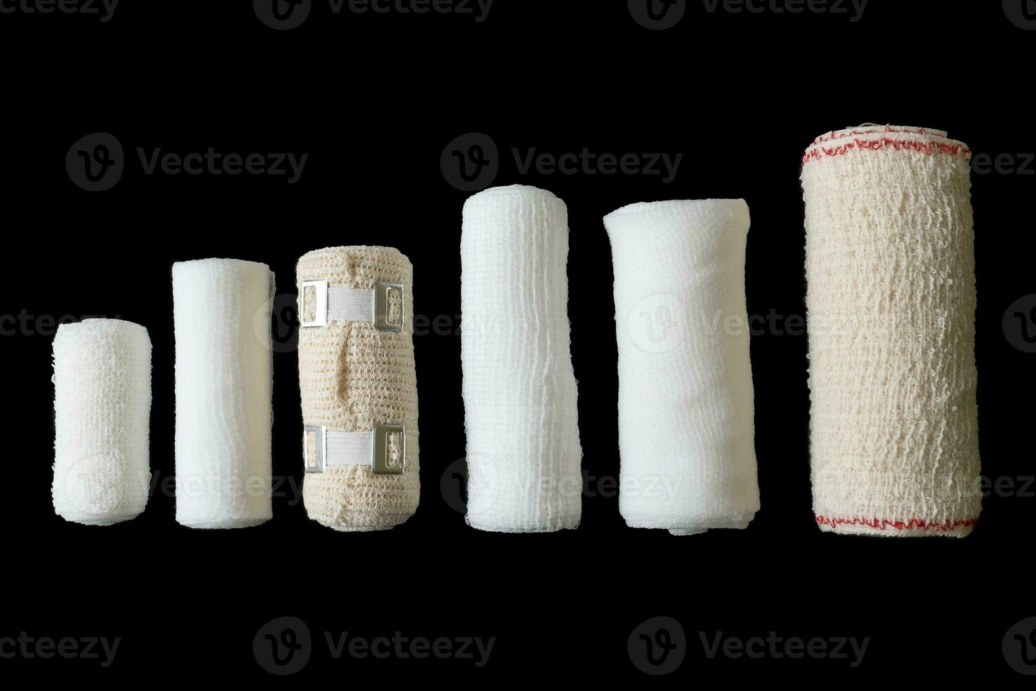 Different sizes of medical bandages. Medical bandages isolated on black background. Medical equipment. photo