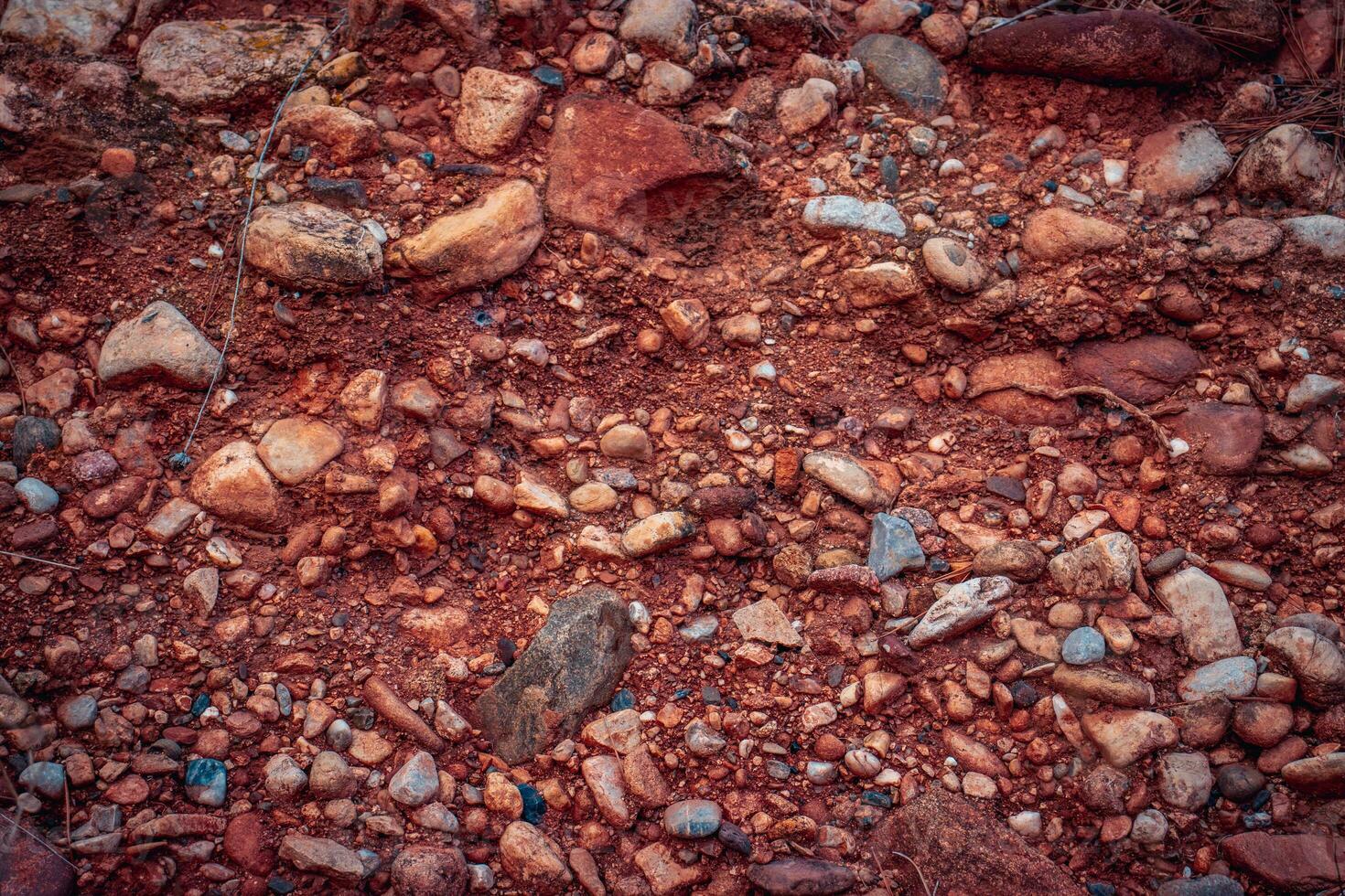 Soil with stones, clay layers photo. Slice of sand with layers of different structures. photo