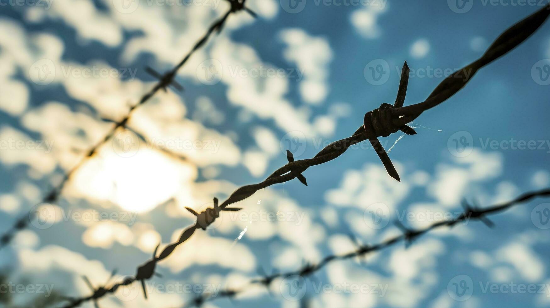 AI generated Barbed wire in front of blue sky with cloud photo