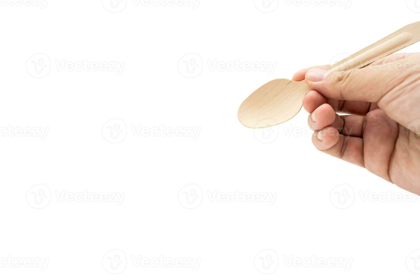 Hand holding Wooden Cutlery. Eco Tableware, Disposable Cutlery, Recycle. Eco food packaging concept, zero waste paper, sustainability. photo