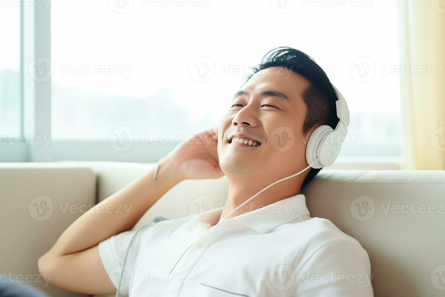 ai generado calma asiático hombre sentado en sofá escuchando a música audio libro disfrutando meditación para dormir y paz foto