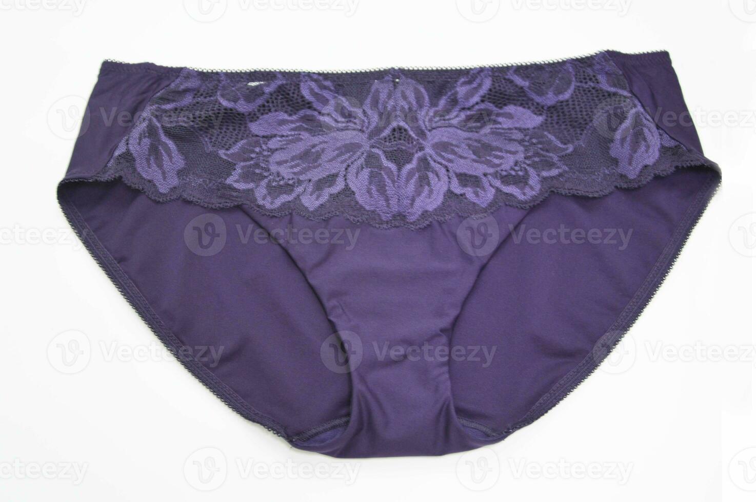 Lingerie. Top view of women's purple lilac lace panties on a white