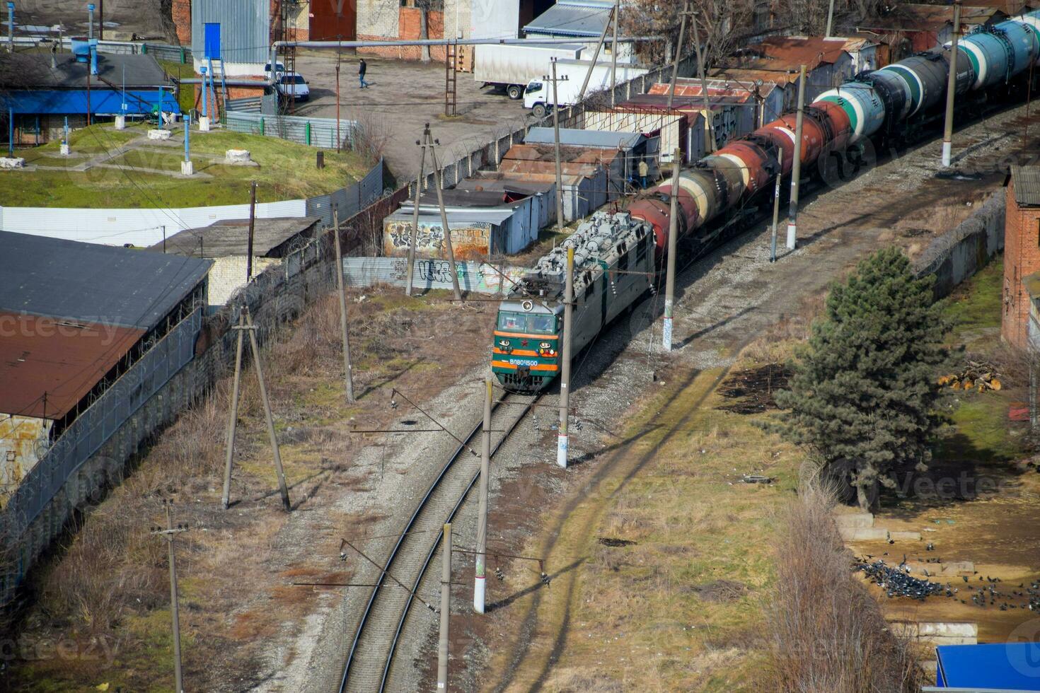 Freight train traveling through the city buildings. photo