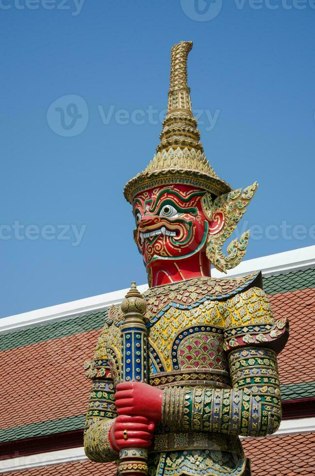 Red Giant Statue Art of Wat Phra Kaew Monastery Travel Landmark at Bangkok of Thailand photo