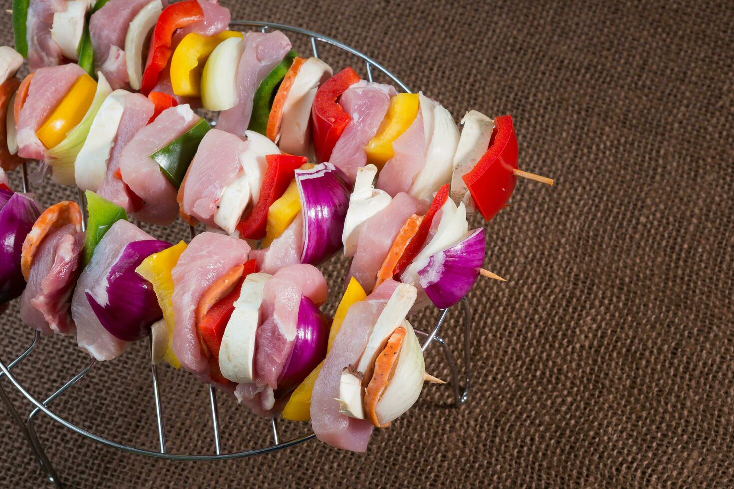 Raw pork skewers ready for grilling photo