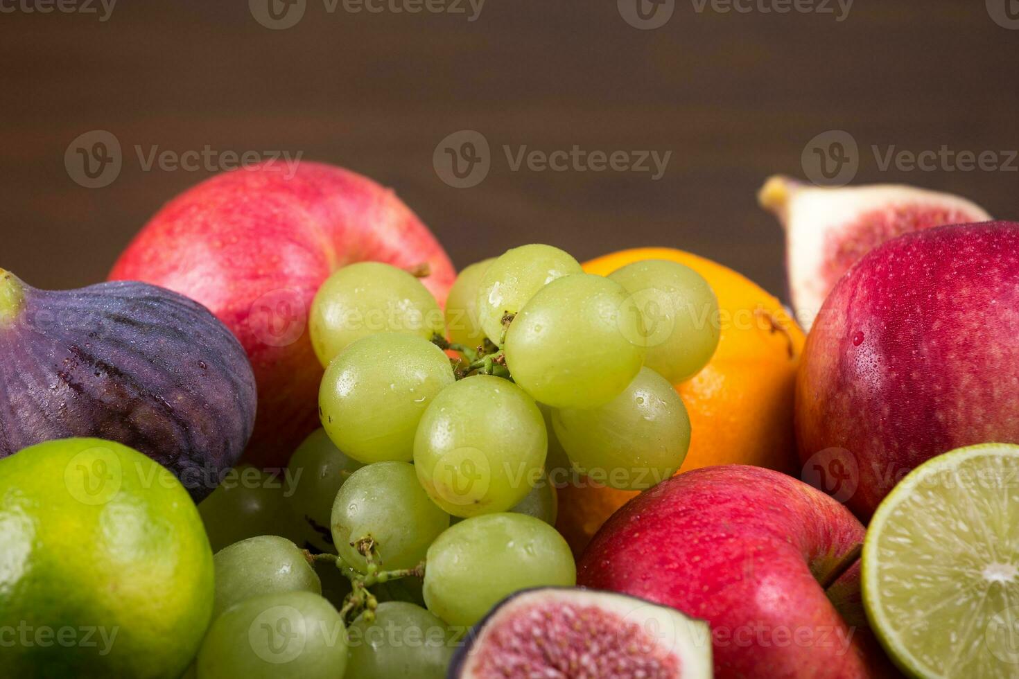 Assortment fruits on wooden table photo