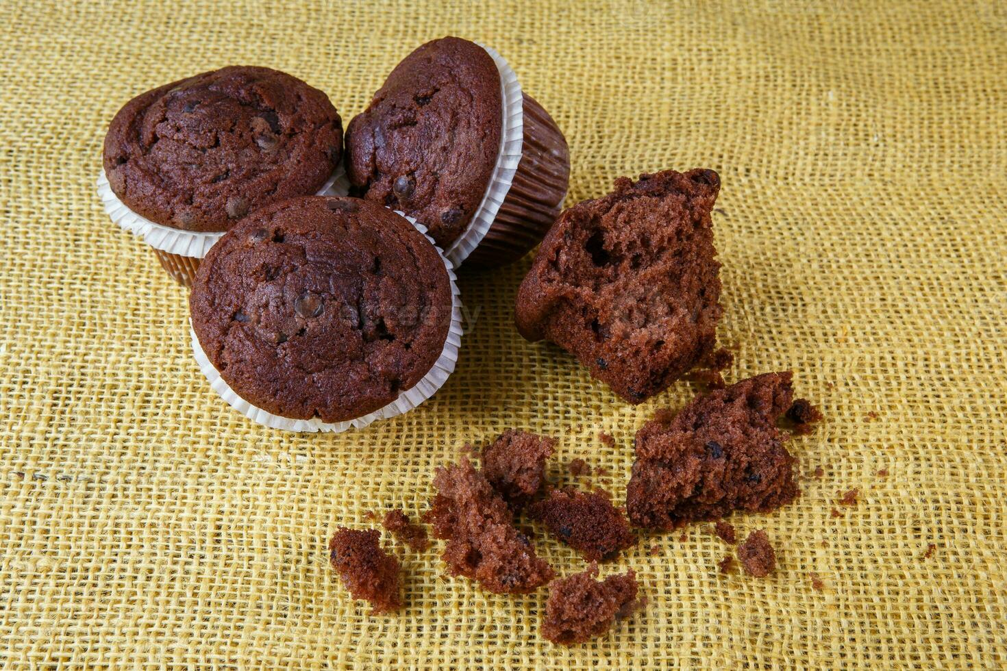 Chocolate chip muffin on a rustic background photo