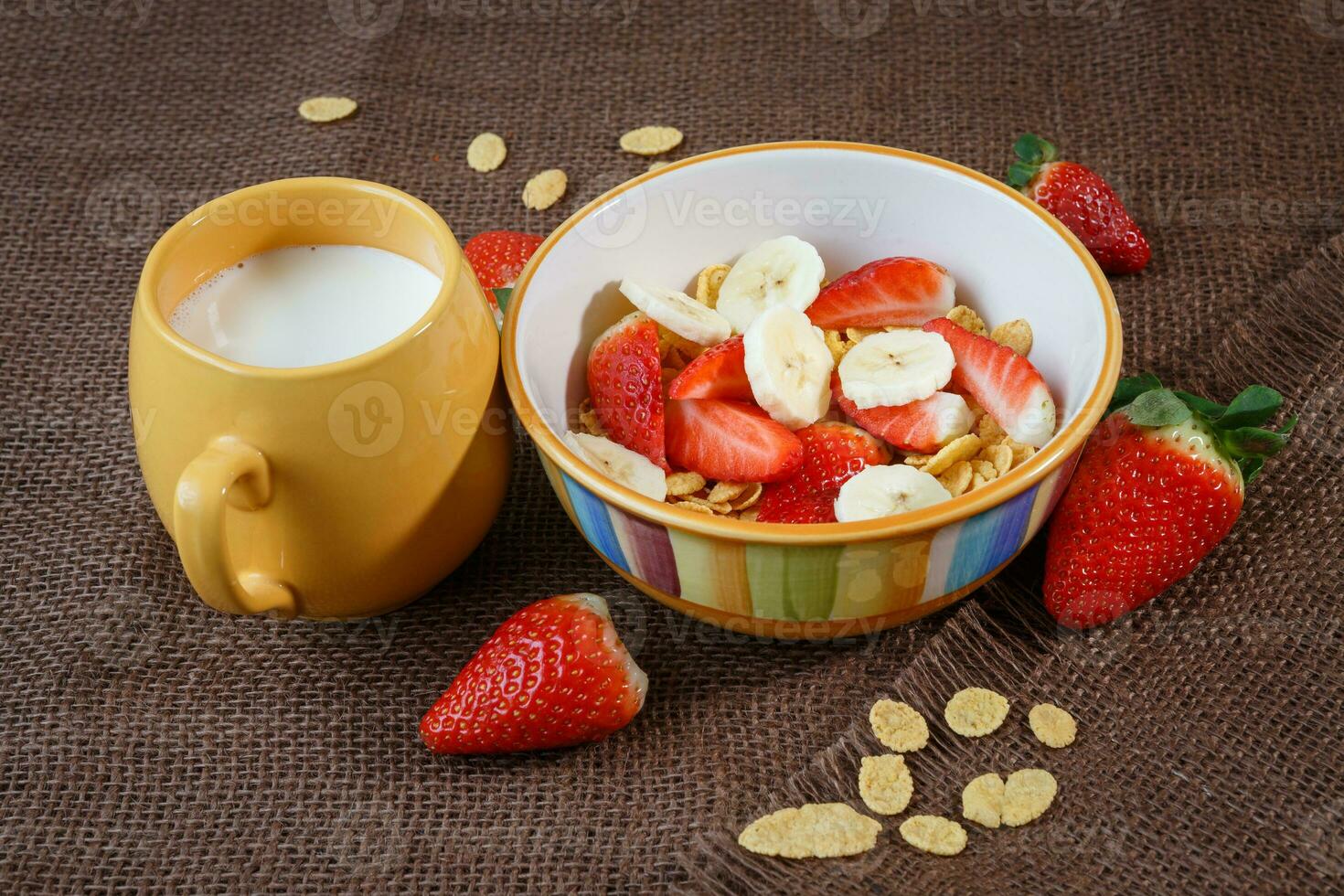 Healthy breakfast. Cornflakes, fresh strawberries, banana and milk photo