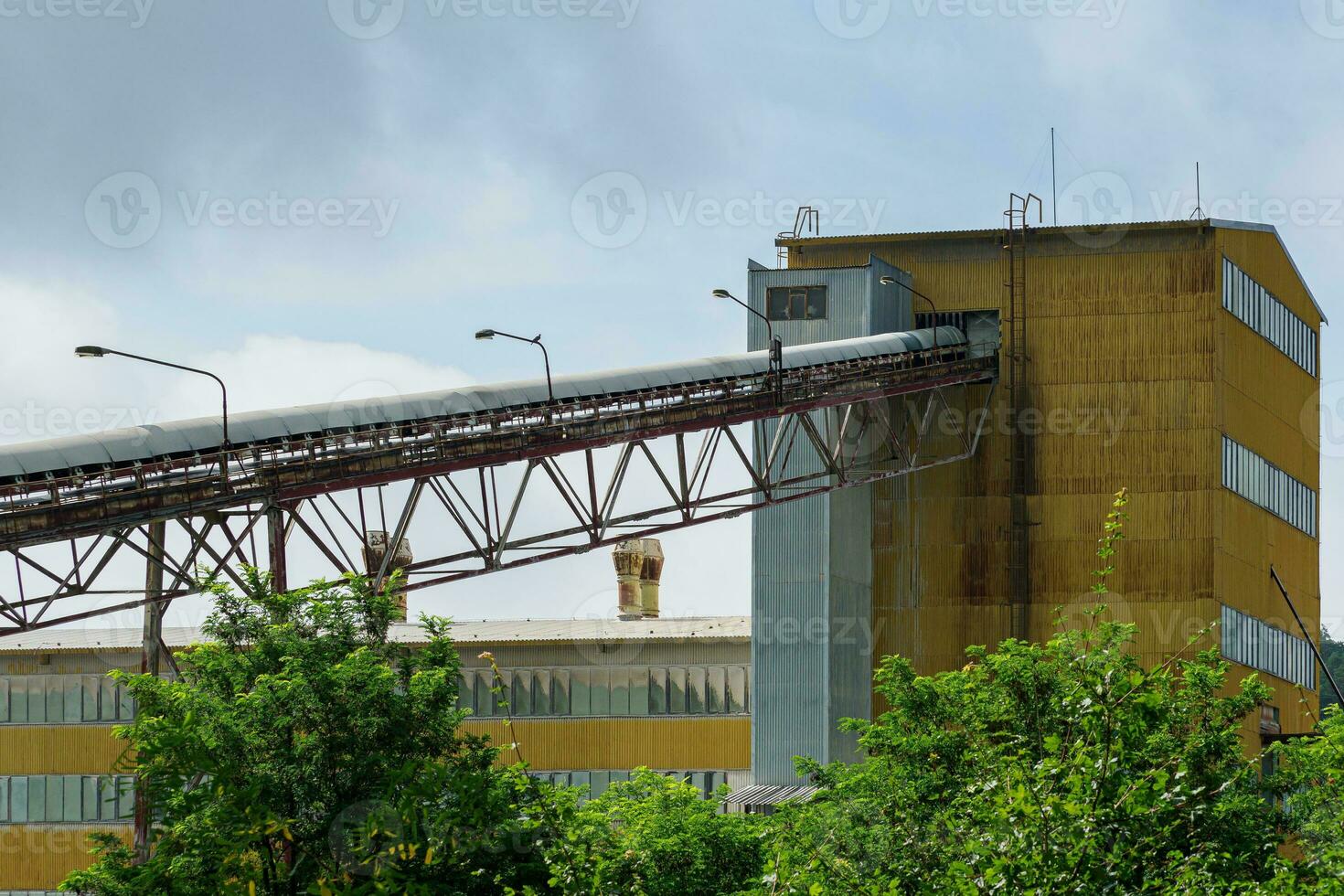 Big silos, belt conveyors and mining equipment in a quarry. Mining industry in quarry. photo