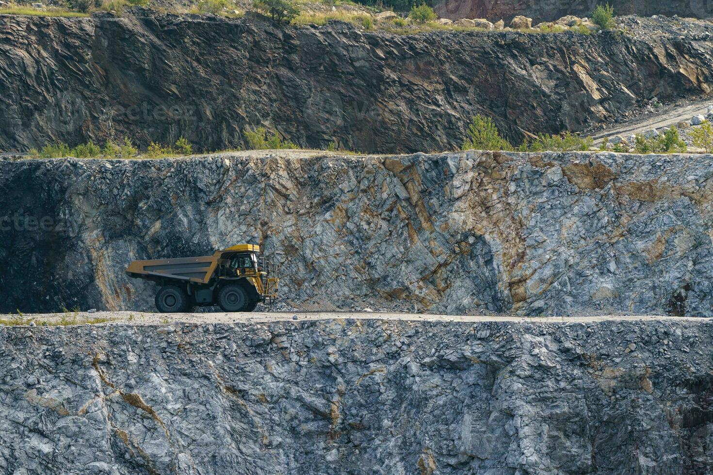 Dump truck in limestone mining, heavy machinery. Mining in the quarry. photo
