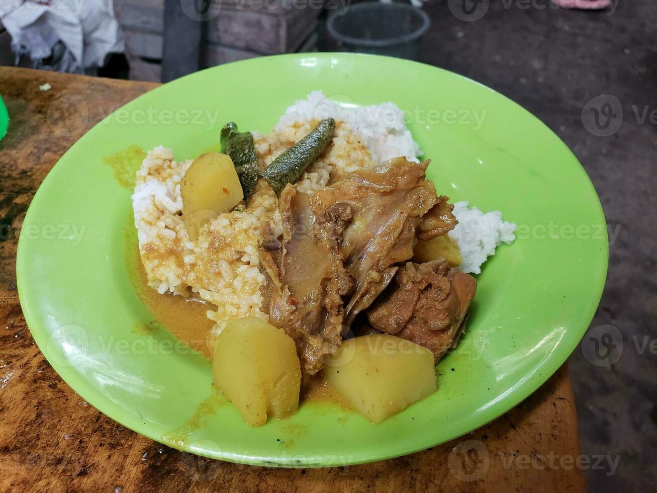 View of cooked chicken served on plate with rice and vegetables photo