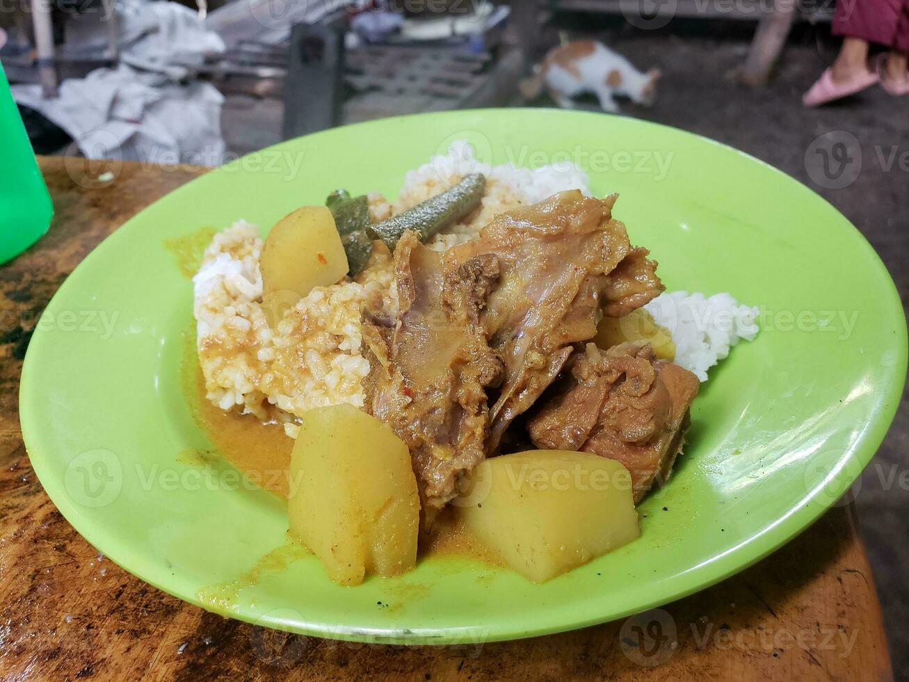 View of cooked chicken served on plate with rice and vegetables photo