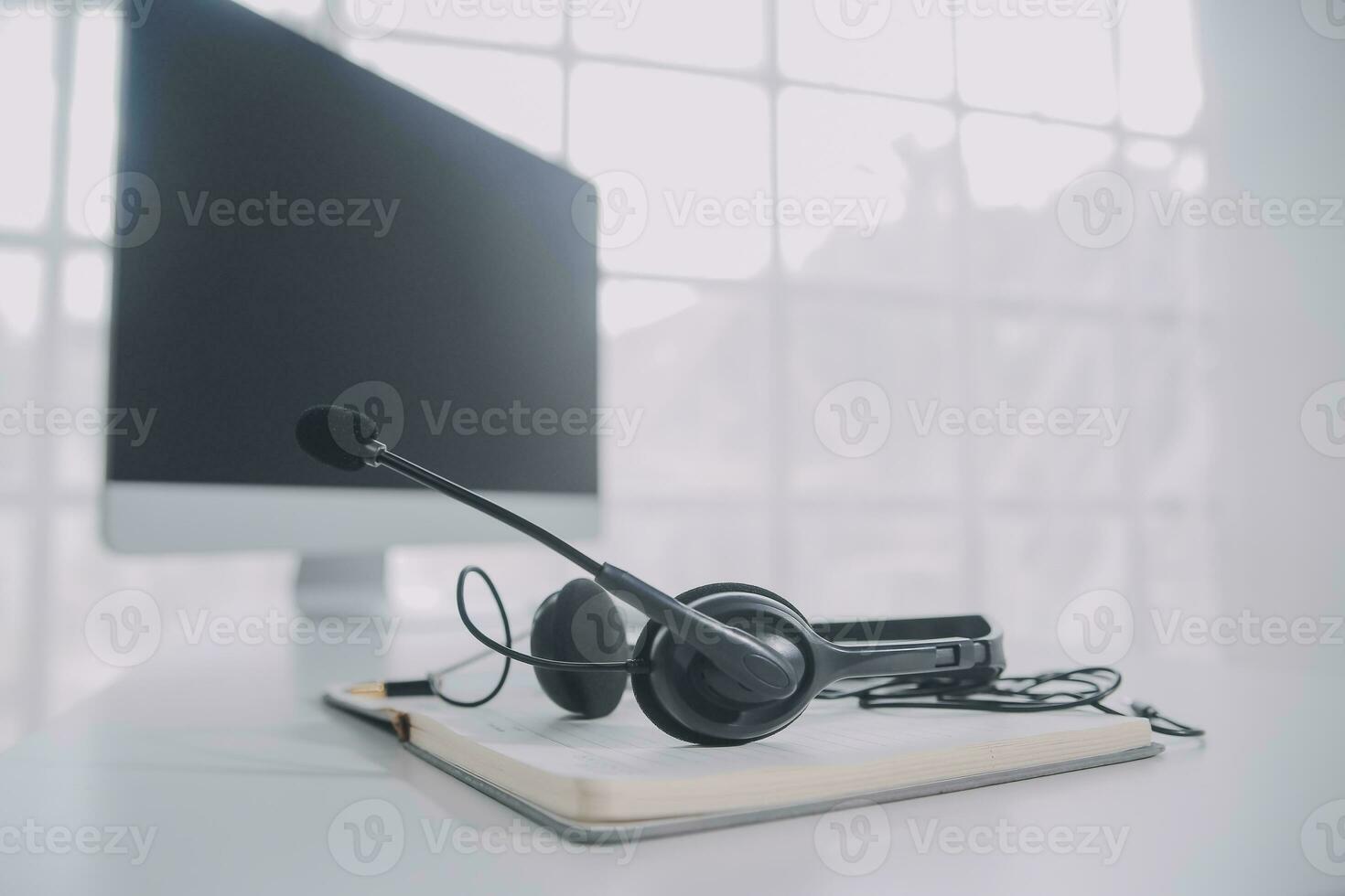 Communication support, call center and customer service help desk. VOIP headset on telephone keyboard. photo