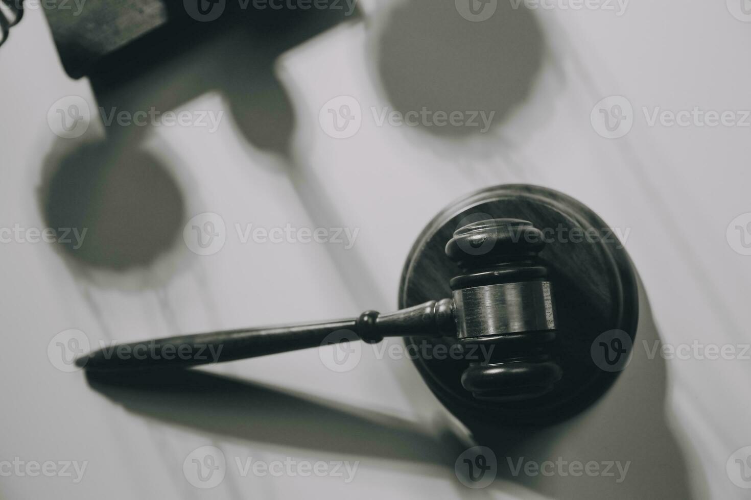 image of judge's hammer, scales lady of justice, law book, laptop computer and contract documents with pen concept of law and justice. photo
