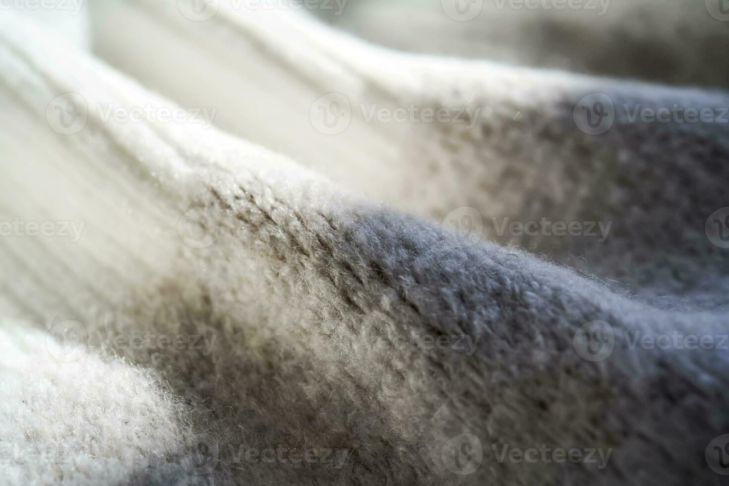 The texture of a warm sweater with a beige pattern. photo