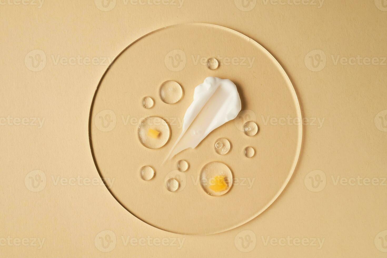 Gel, serum and a cream on a transparent round stand on a beige background. photo