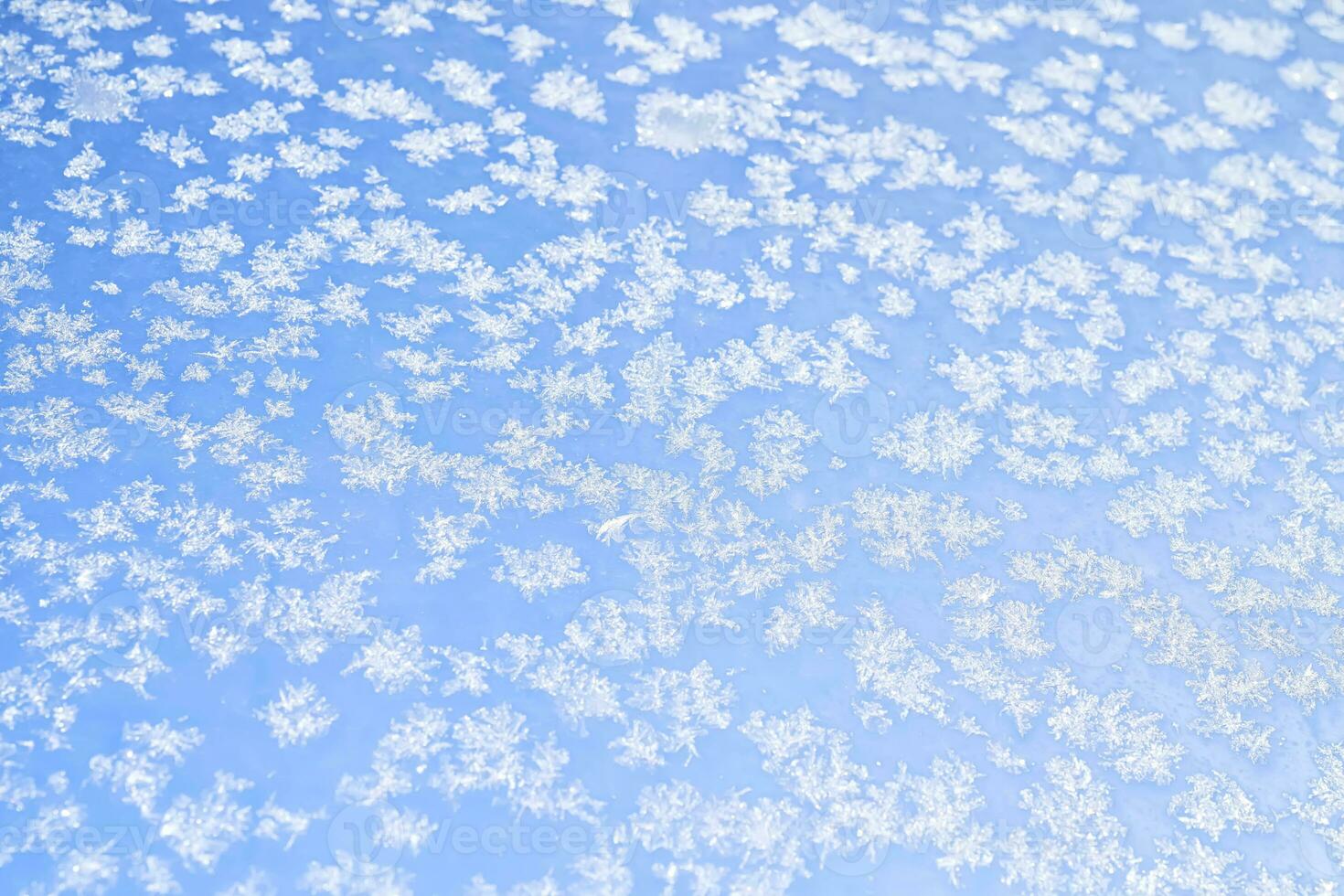Abstract winter background. Frost on a frozen window against the blue sky. photo