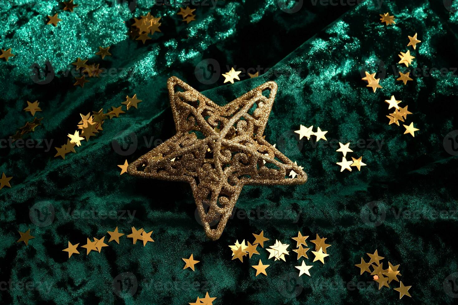 Abstract Christmas background with gold stars on a green velvet background. photo