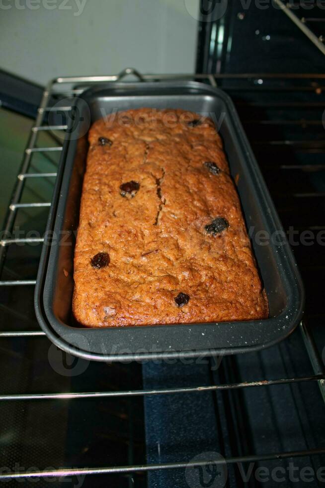 Banana bread with raisins in oven 6 photo