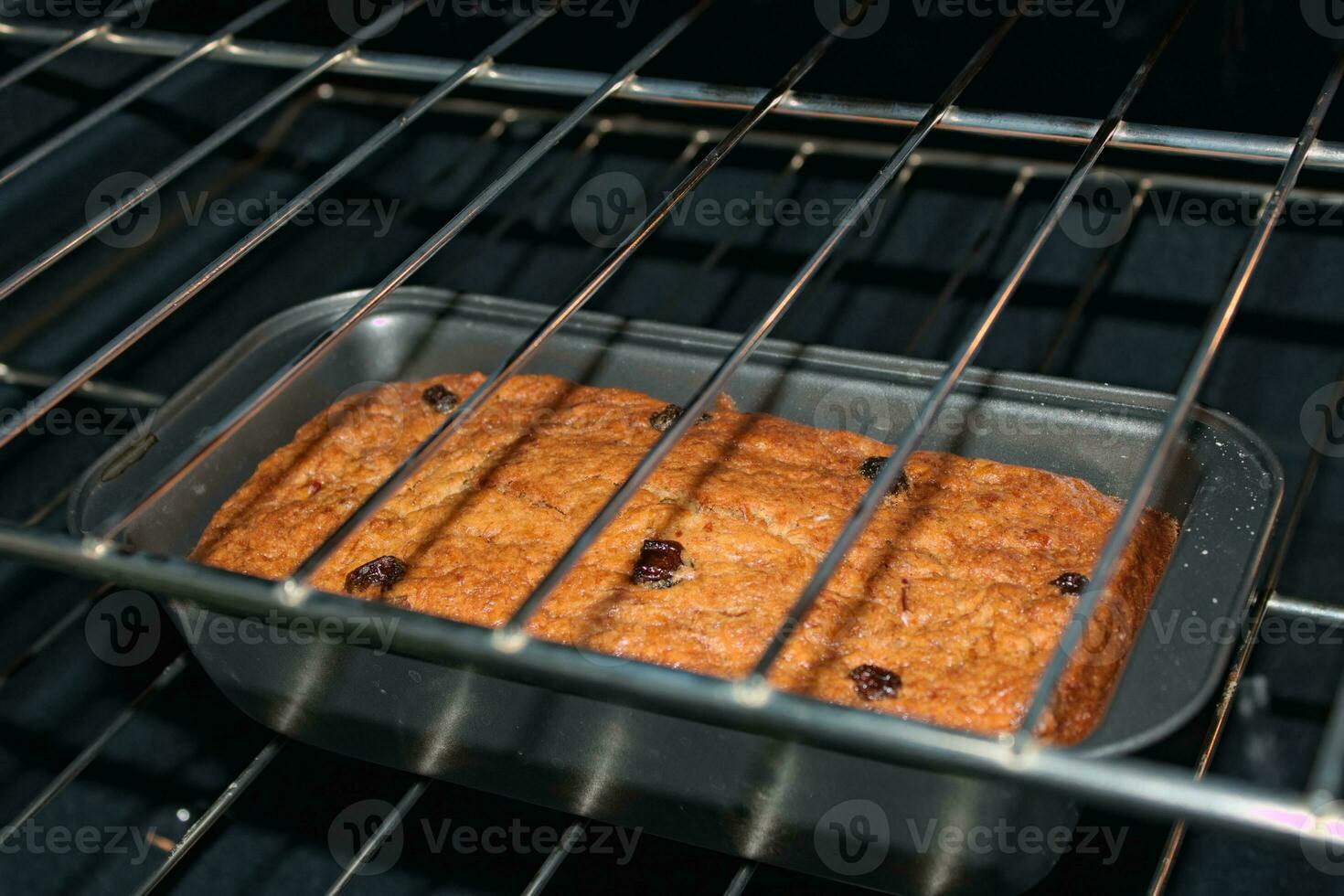 Banana bread with raisins in oven 4 photo