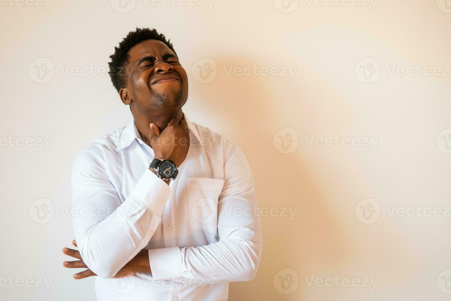 Portrait of young businessman who is having pain in his neck glands. Copy space on image for your text or advert. photo