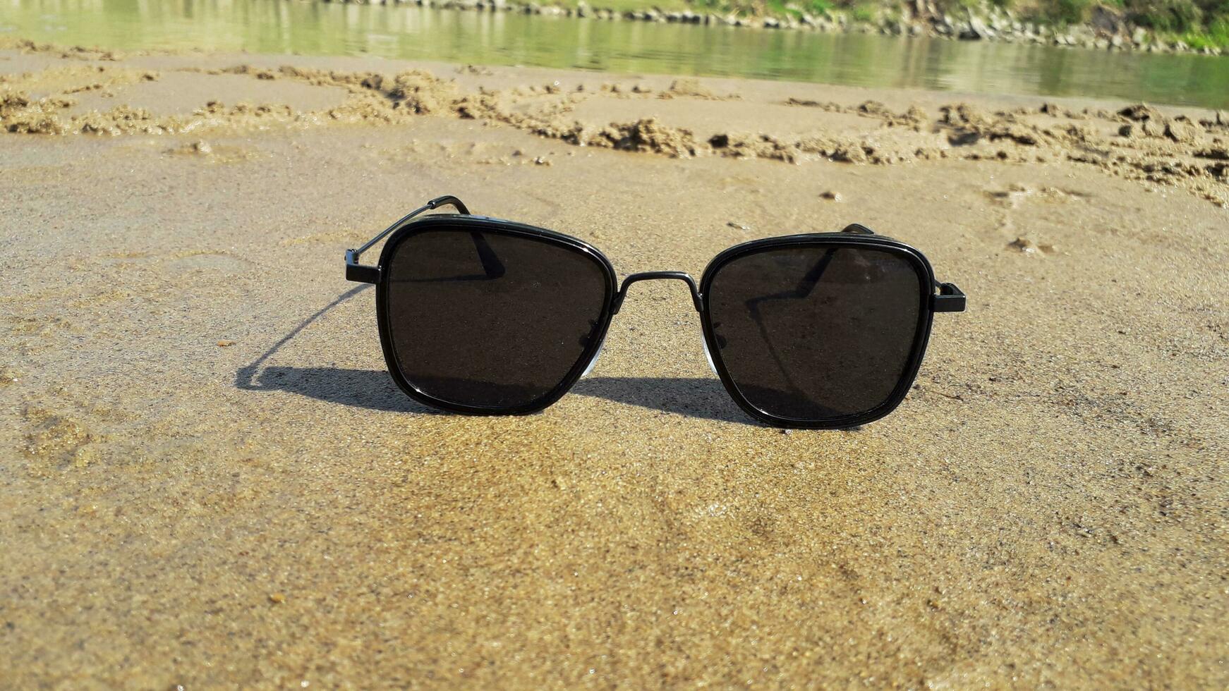 Black Sunglasses On The Sand photo