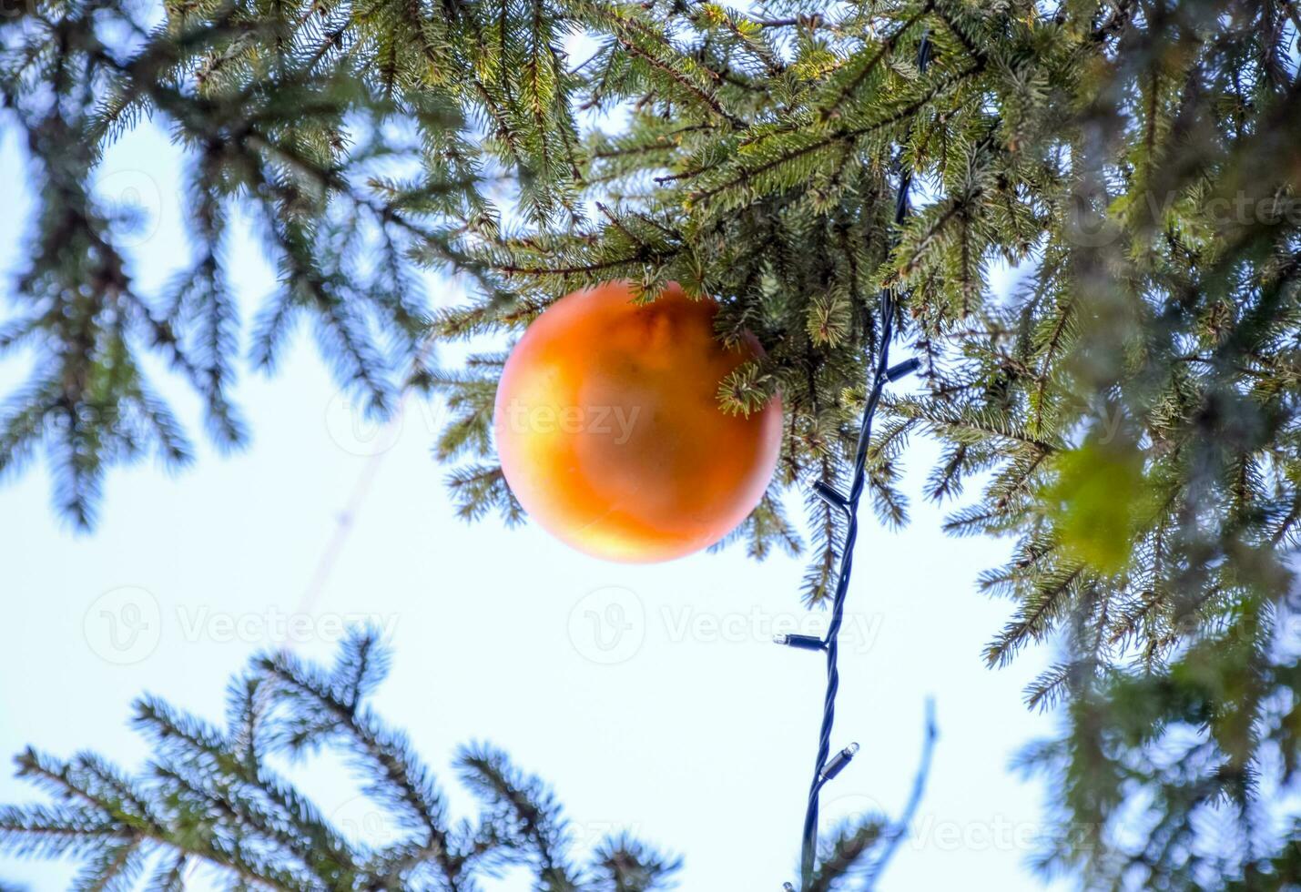 Decorations New Year tree. Tinsel and toys, balls and other decorations on the Christmas Christmas tree standing in the open air. photo