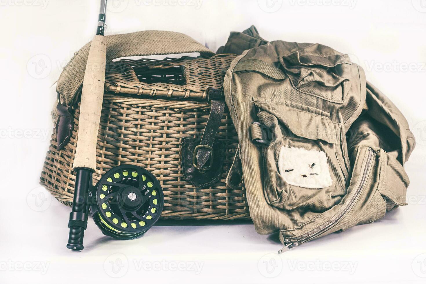 Fly Fishing Rod, Vest and Fish Creel on a White Background photo