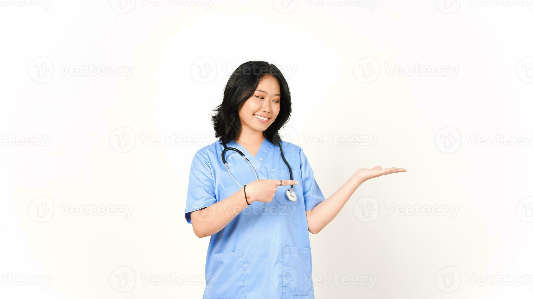 Young Asian female doctor pointing copy space on palm hand isolated on white background photo
