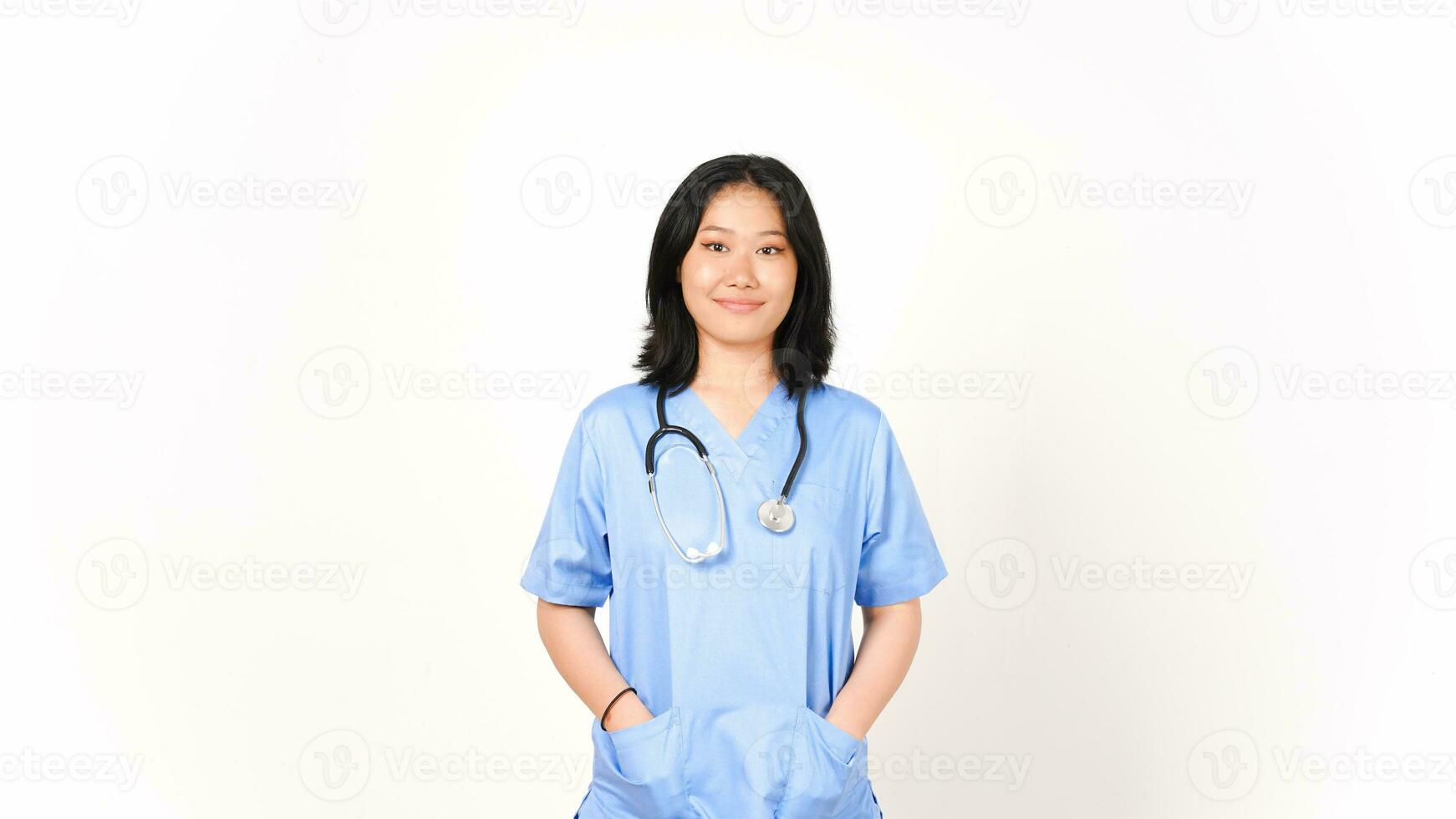 Young Asian female doctor hands on pocket looking camera and smile isolated on white background photo