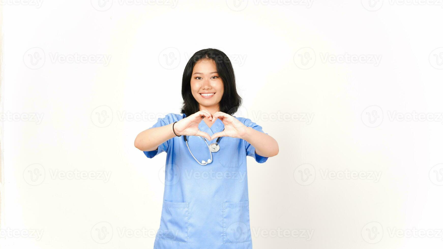 Young Asian female doctor showing love sign isolated on white background photo
