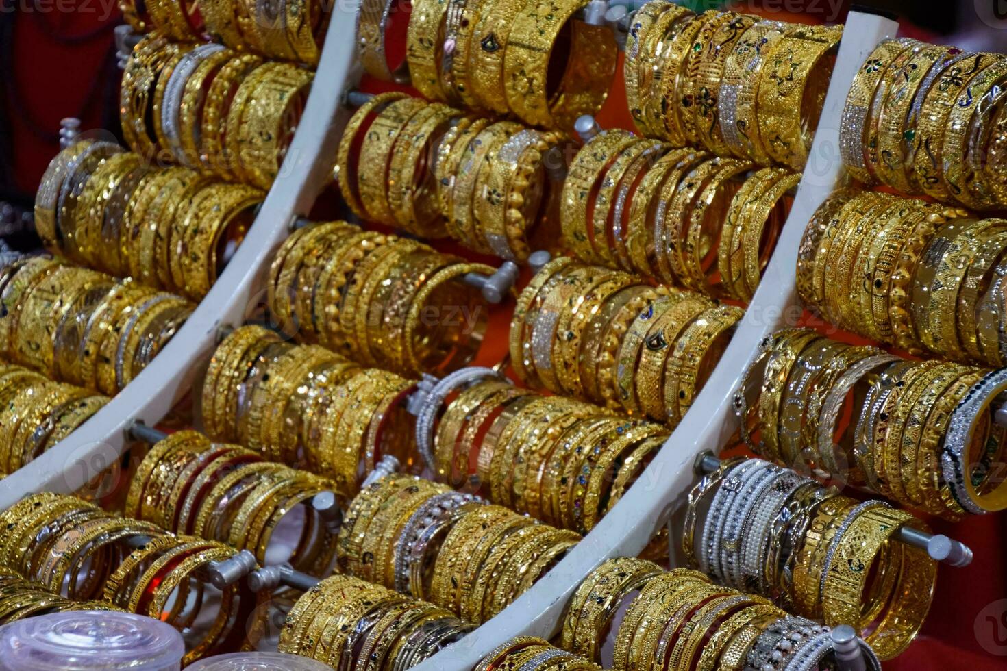 Indian rings and bracelets in silver and gold and jewelry on the counter in store. photo
