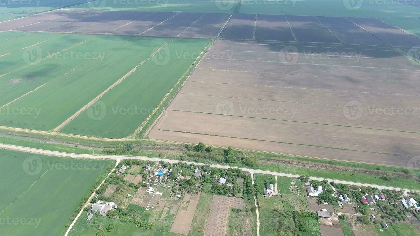Top view of the village. One can see the roofs of the houses and gardens. Road in the village. Village bird's-eye view photo
