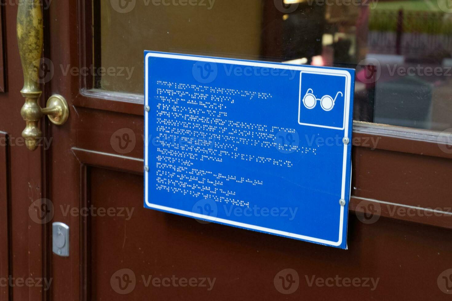 plate with a tongue for the blind on the doors of the building. photo