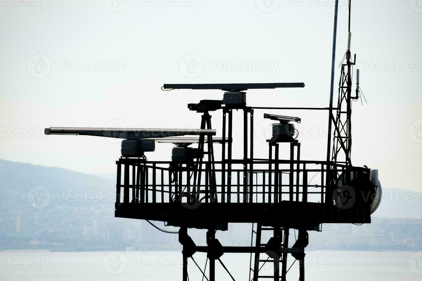 Rotating antennas of a military radio station on tower. photo