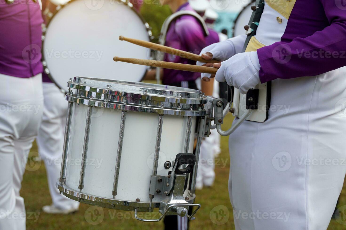 Marching band drummer plays music during the school sports day parade.Soft and selective focus. photo