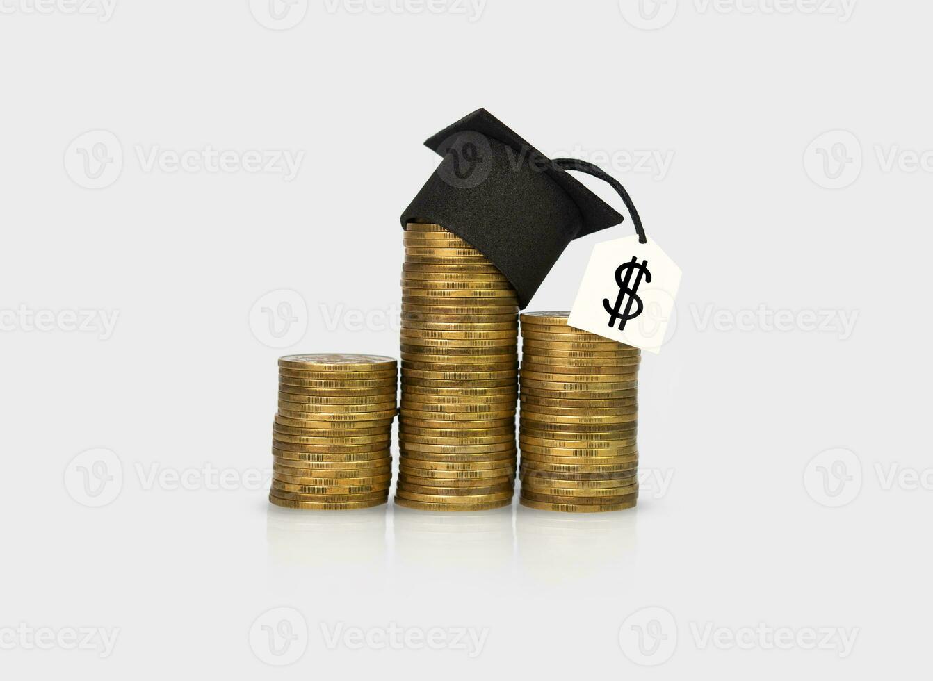 Concept of financial literacy and education. Graduation hat on gold coins. photo