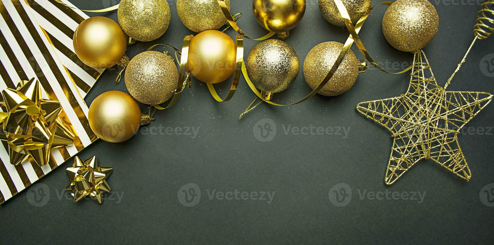 Christmas gold balls and decorations on a dark background. New Year decor. Christmas background. Copy space. photo