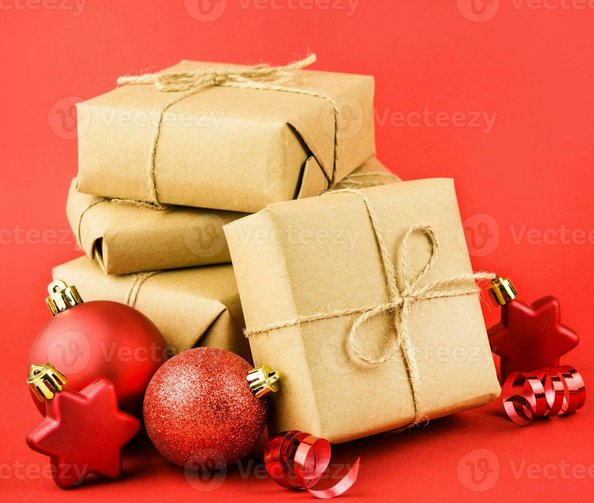 Christmas composition of gifts, red balls, serpentine and stars on a red background. Festive Christmas decorations. Christmas background. Banner layout, postcard. Flat lay. Copy space. photo