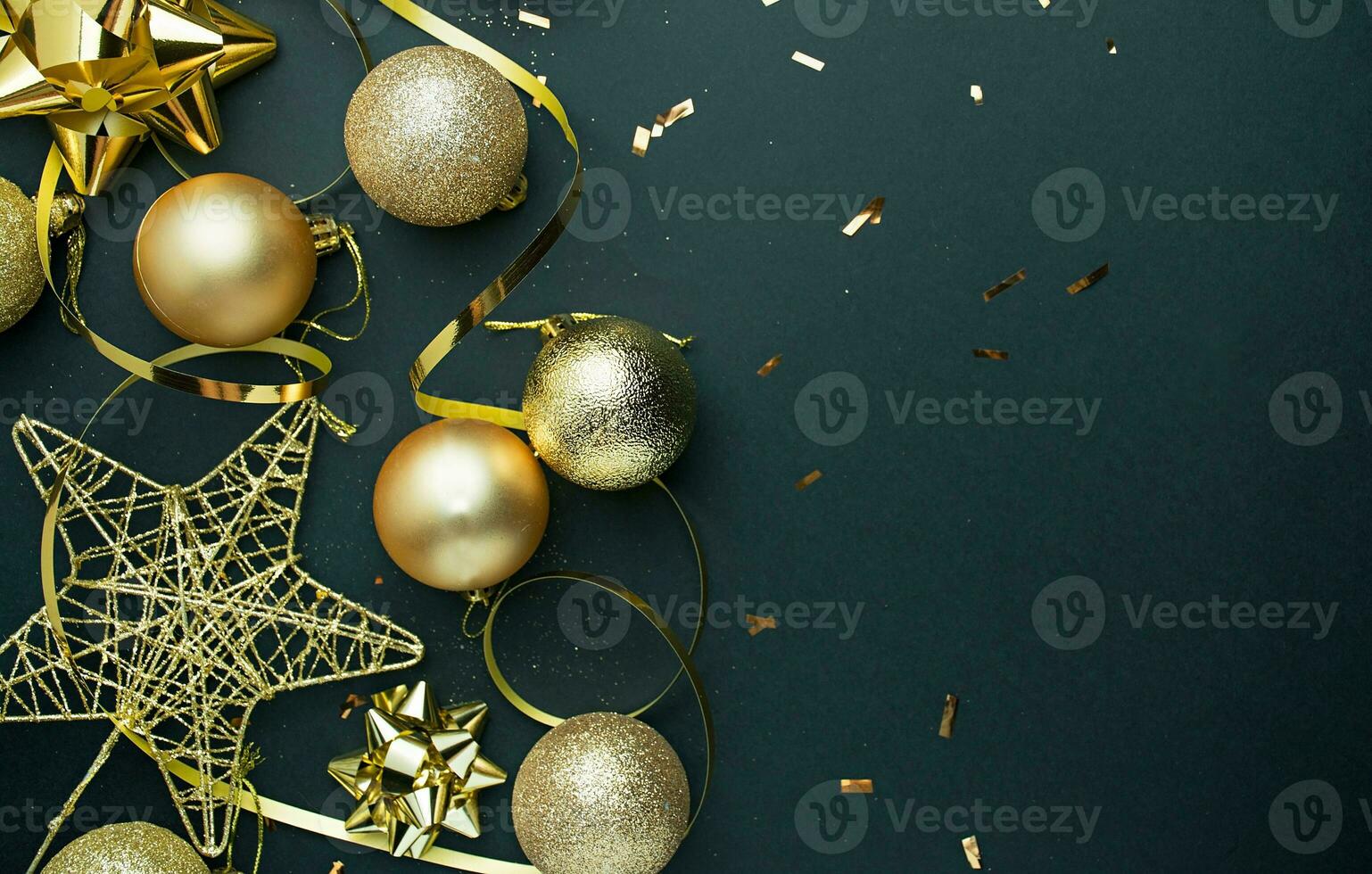 Christmas background. Christmas golden deco bubblers on a dark black background. New Year decoration . photo
