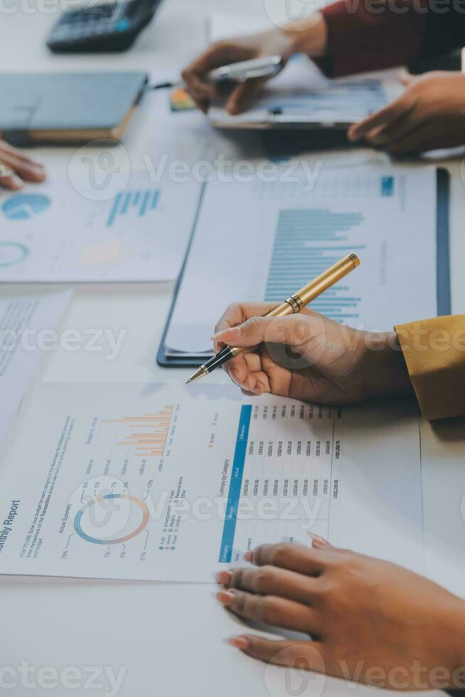 Financial analysts analyze business financial reports on a digital tablet planning investment project during a discussion at a meeting of corporate showing the results of their successful teamwork. photo