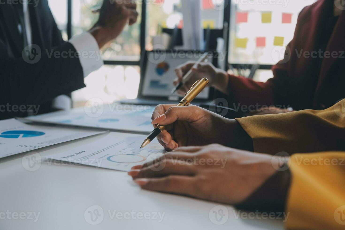 Financial analysts analyze business financial reports on a digital tablet planning investment project during a discussion at a meeting of corporate showing the results of their successful teamwork. photo