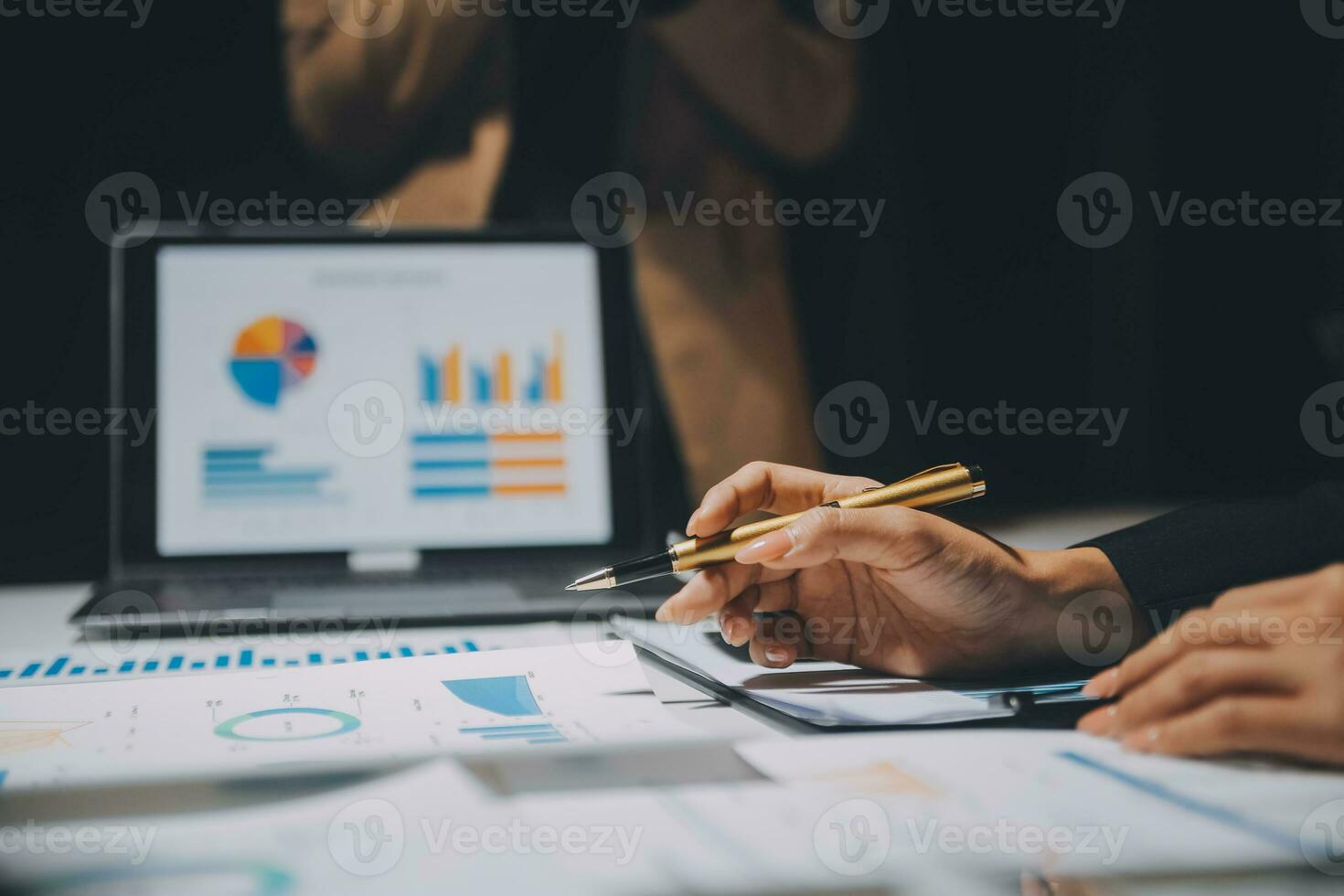 Financial analysts analyze business financial reports on a digital tablet planning investment project during a discussion at a meeting of corporate showing the results of their successful teamwork. photo