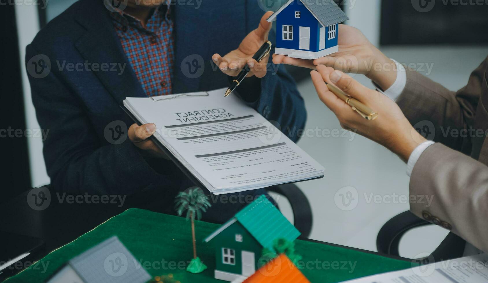 Real estate brokerage agent Deliver a sample of a model house to the customer, mortgage loan agreement Making lease and buy and sell house And contract home insurance mortgage loan concept photo