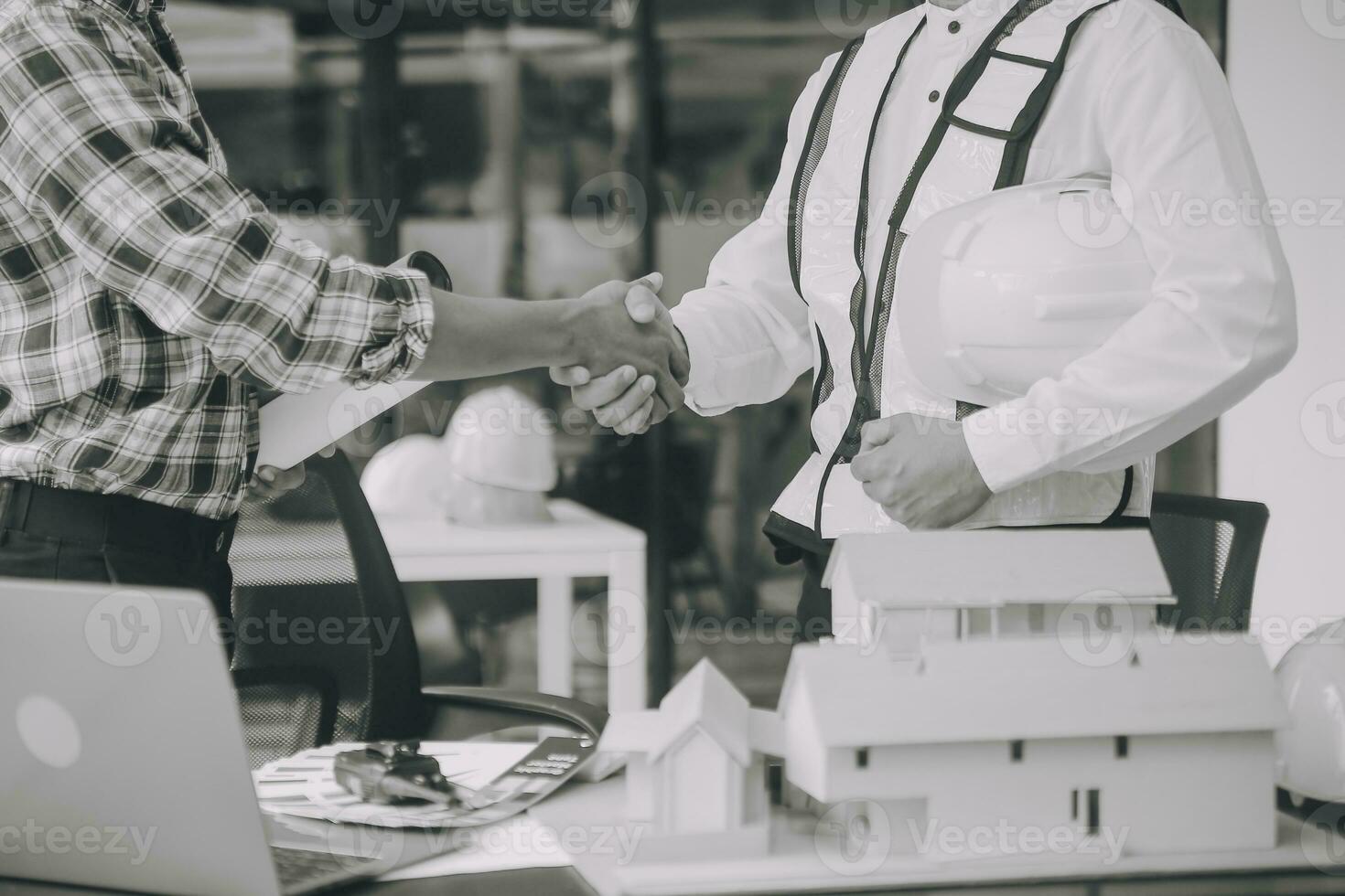 Construction and structure concept of Engineer or architect meeting for project working with partner and engineering tools on model building and blueprint in working site, contract for both companies. photo